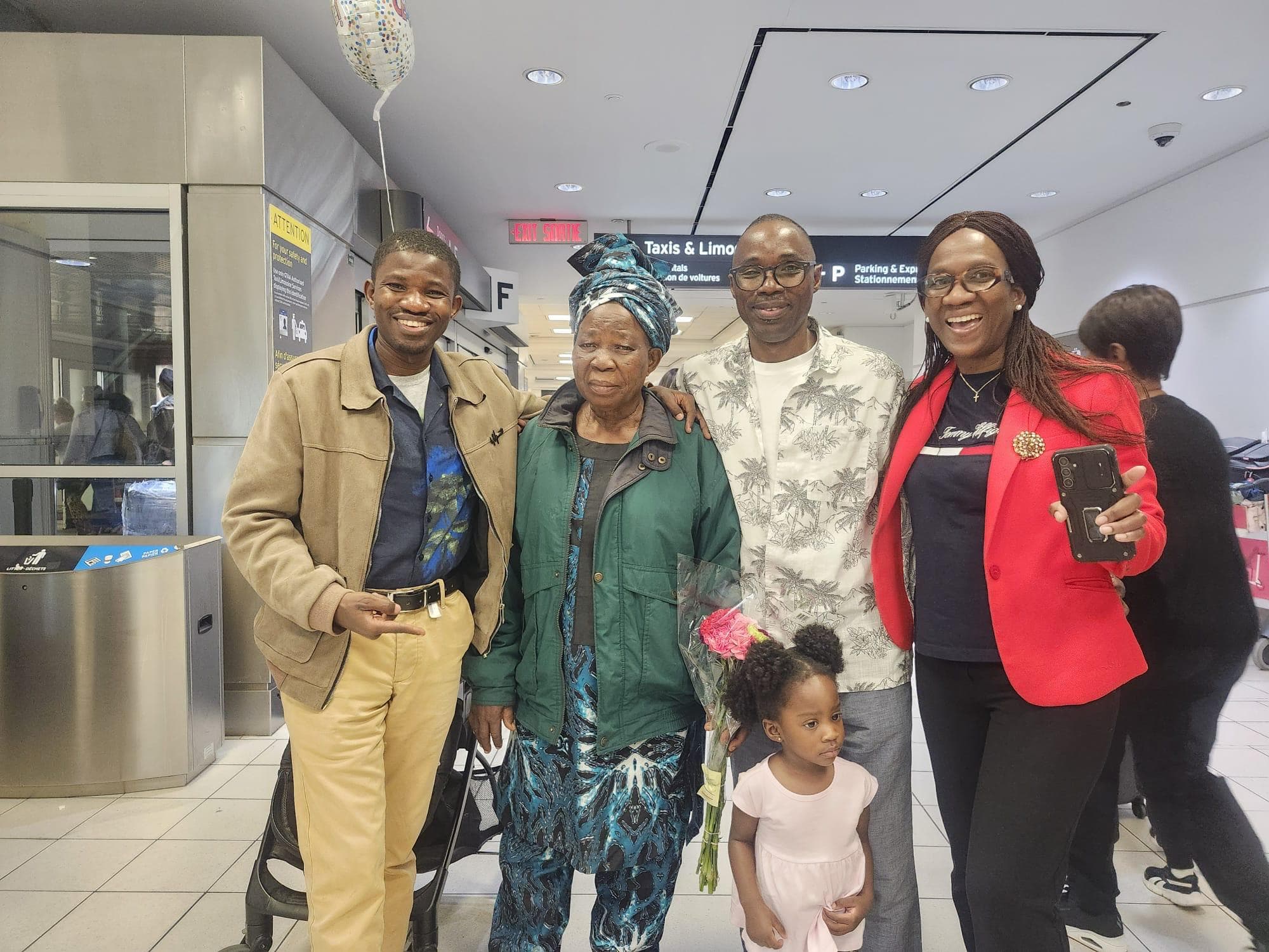 Deaconess Deborah Olubisi Oloyede with family members and a young child at an airport