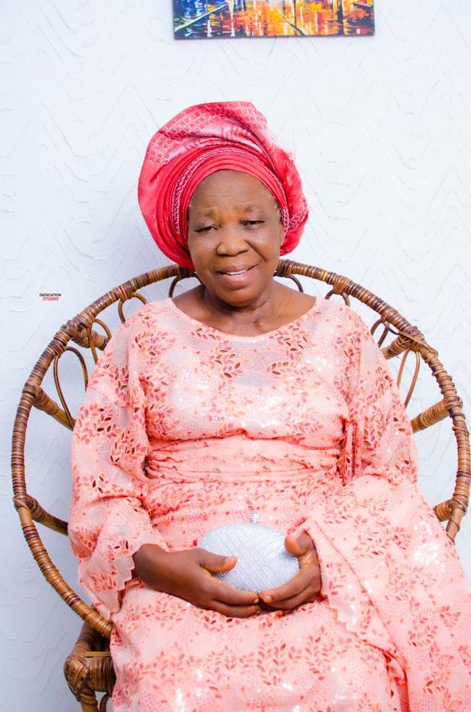 Deaconess Deborah Olubisi Oloyede seated in peach traditional attire and a red gele