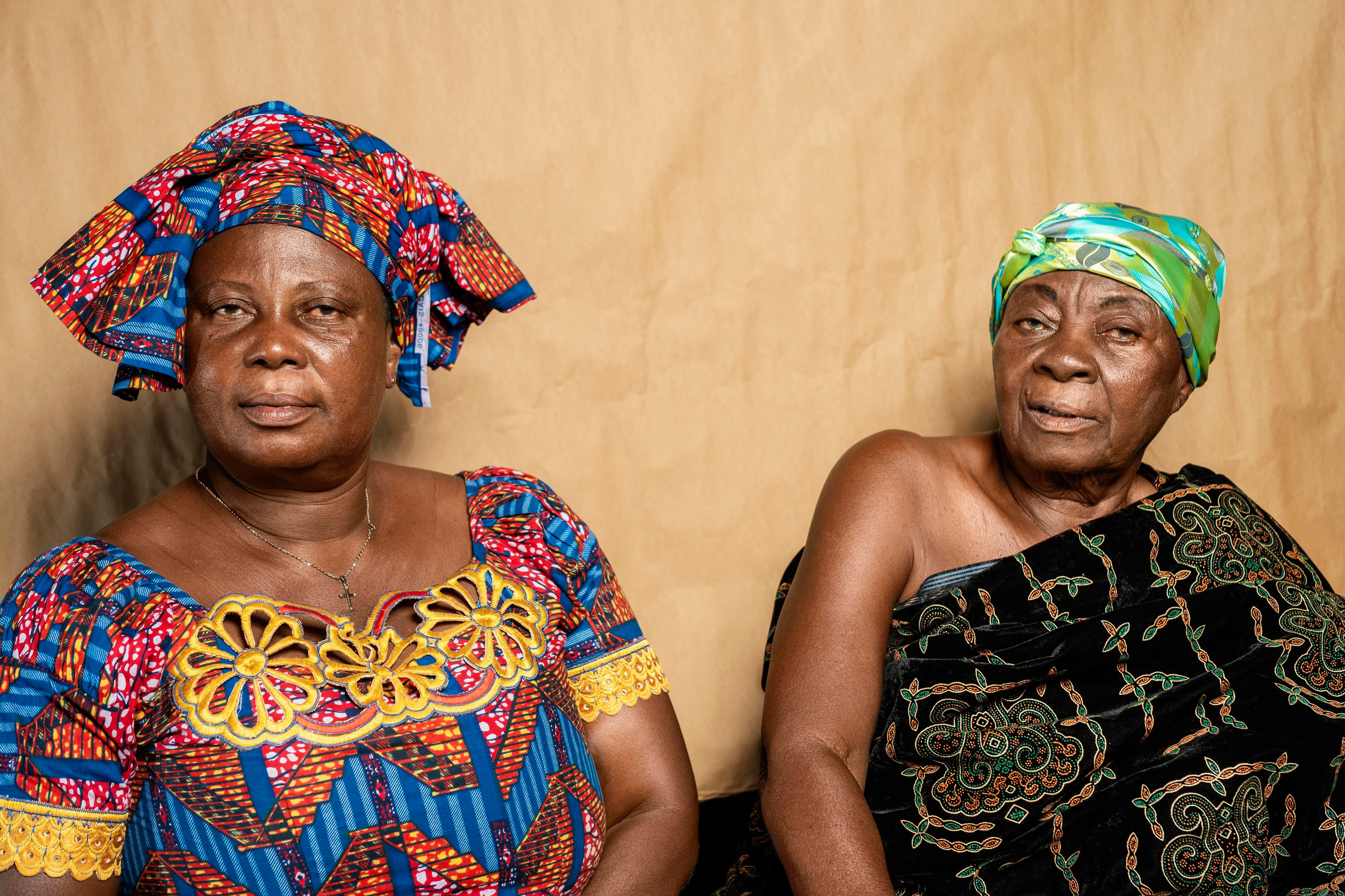 Two older African women wearing colourful traditional clothing