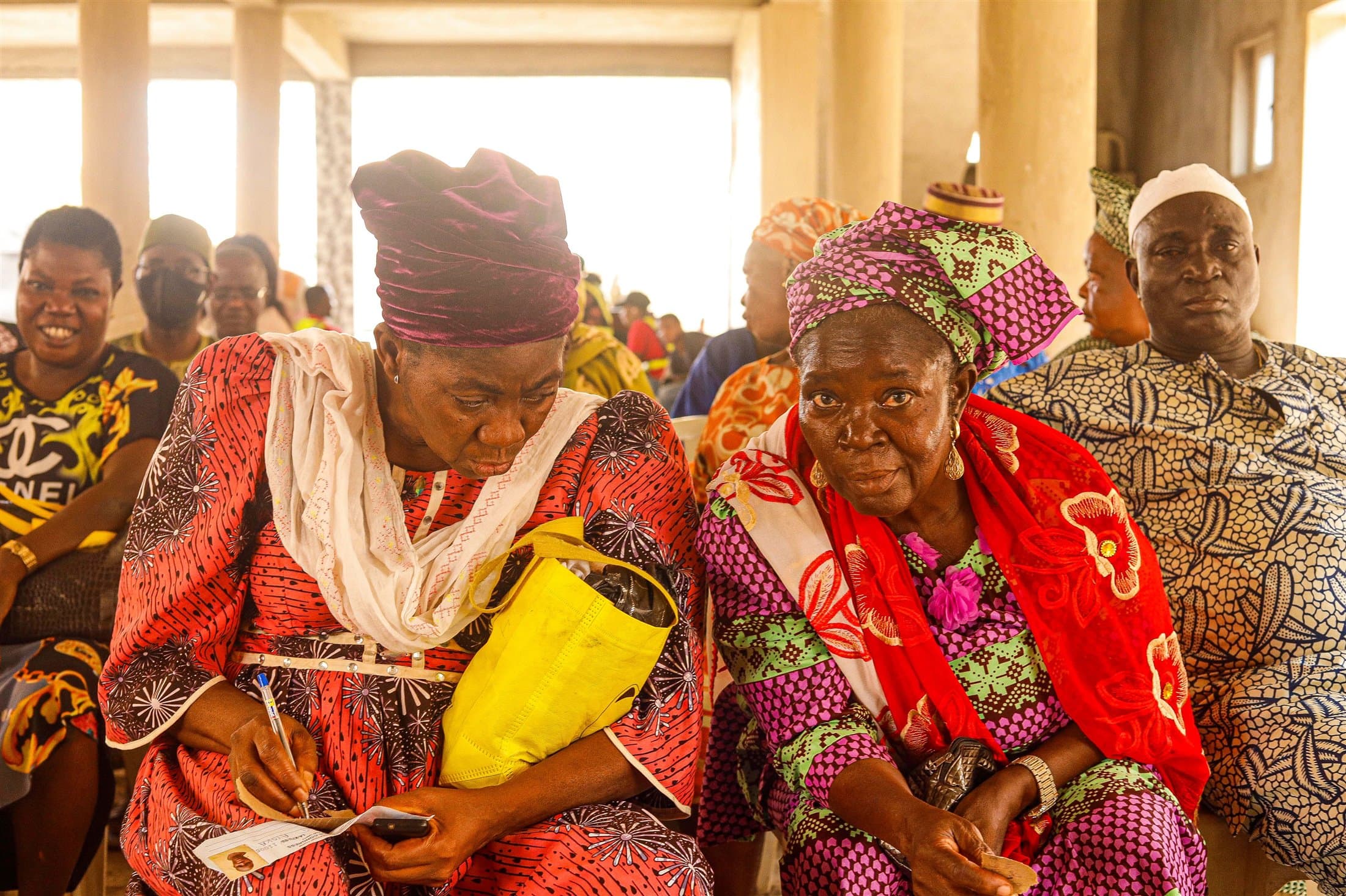 A gathering of Nigerian women and men in colourful traditional clothing
